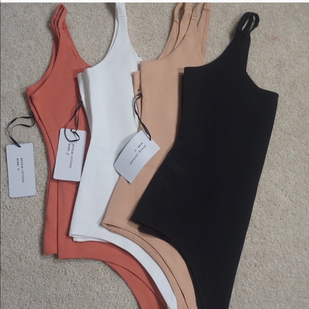 3 bodysuits white, peach and tan